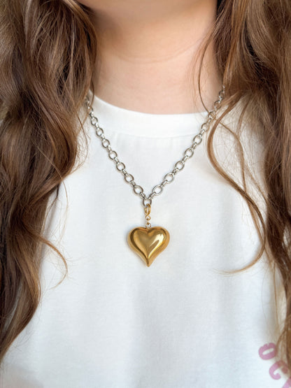Zilveren schakelketting met een gouden grote hart bedel